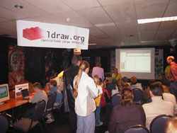 An interested audience listens to Jaco van der Molen present LDraw via the projector.